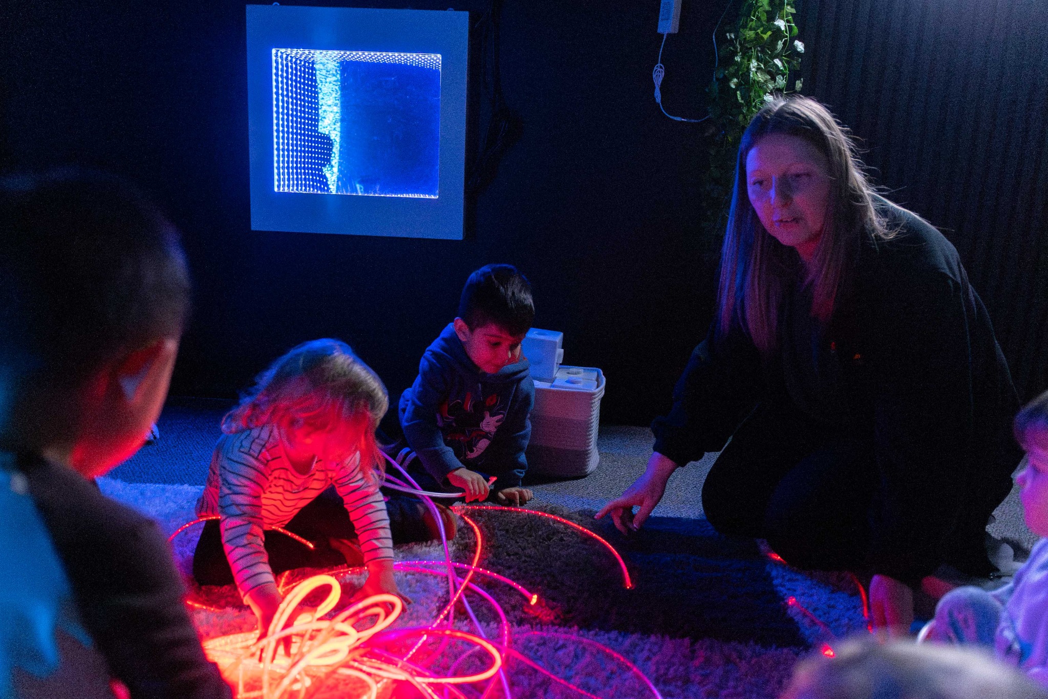 Children exploring light and colour in a sensory room